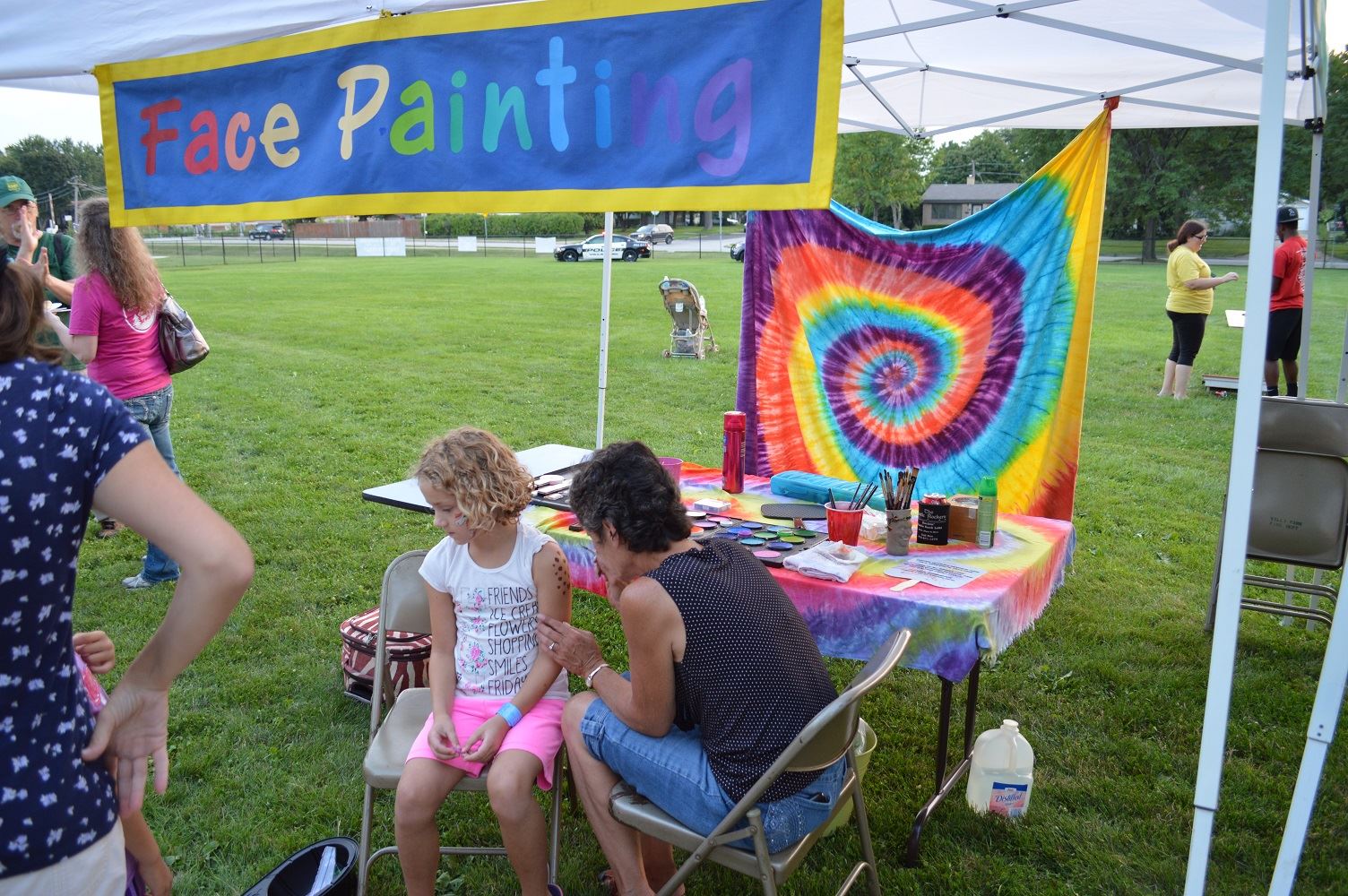 A young girl gets her arm painted at a National Night Out event at the Iowa Community Center, Aug. 2.
